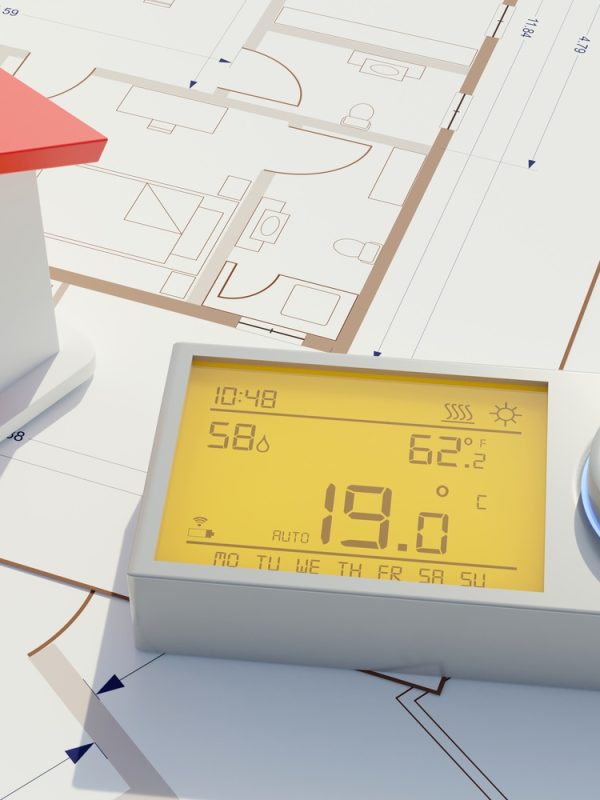 Building Energy cost saving. Heating thermostat on house drawing.